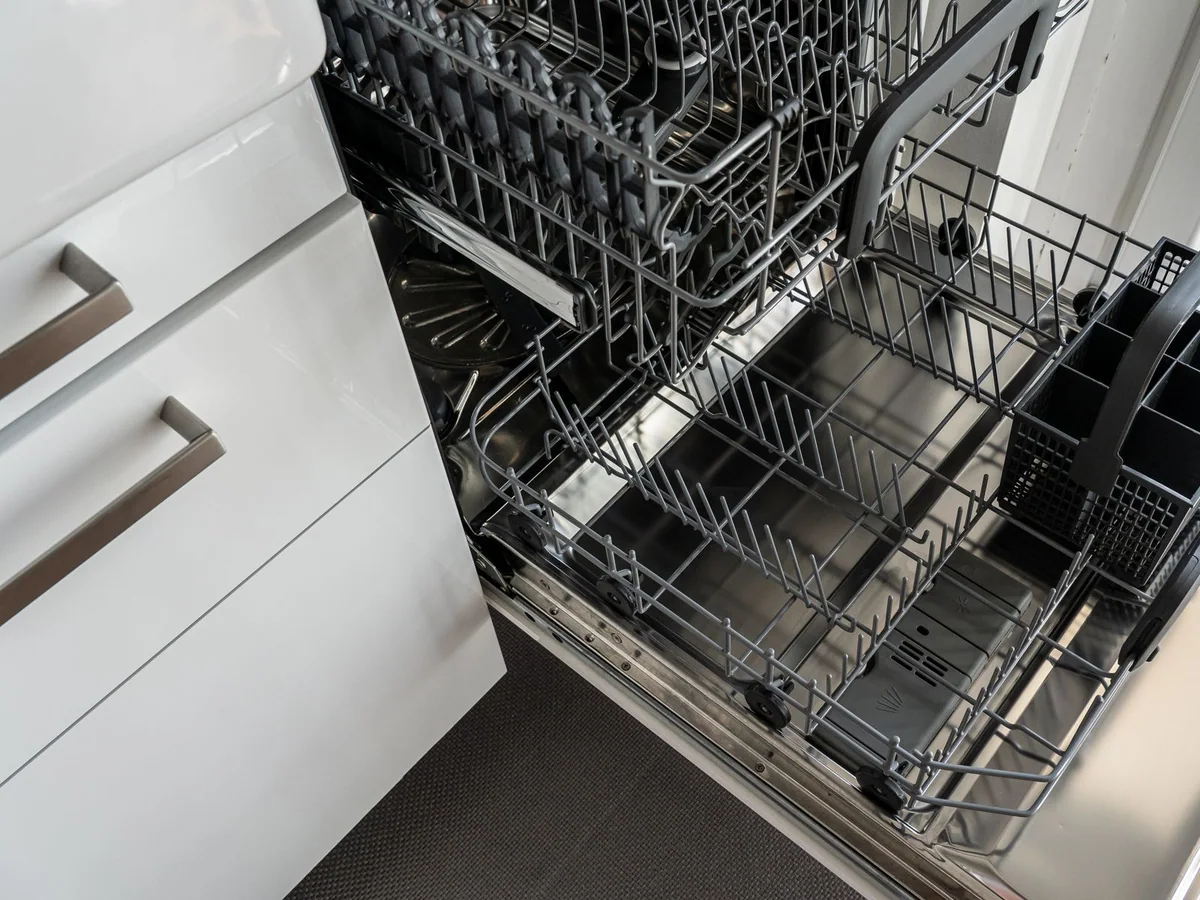 A quiet dishwasher beneath a counter in an open kitchen and dining room
