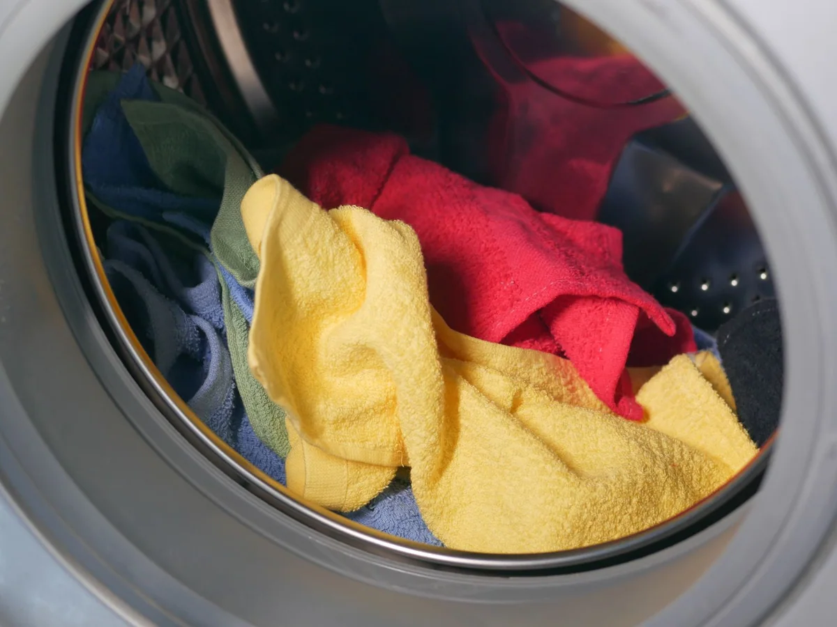 A compact washer-dryer combo installed in a small apartment utility closet