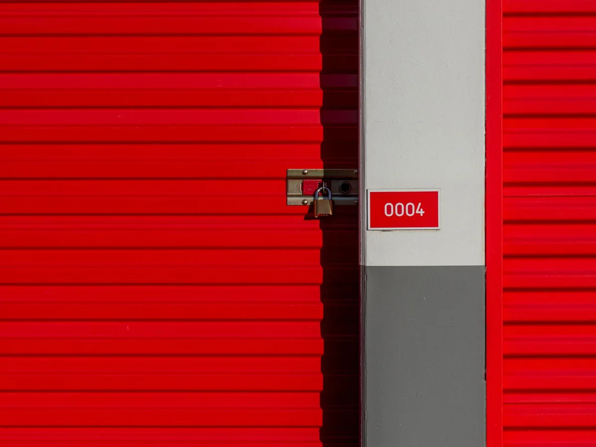 Labeled stackable storage bins on heavy shelving in a tidy garage