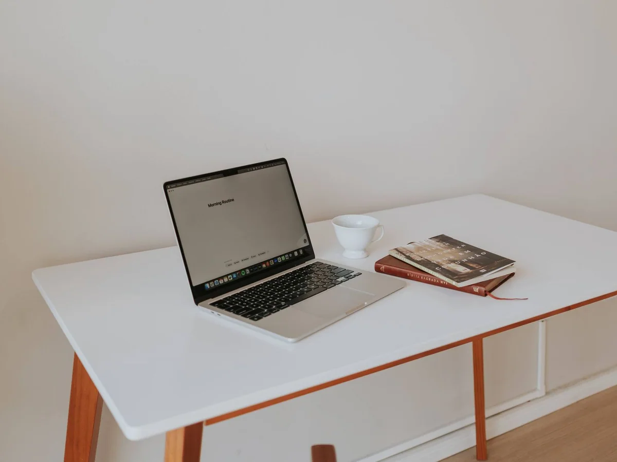 A home office with a fold-down bed and a desk on the opposite wall