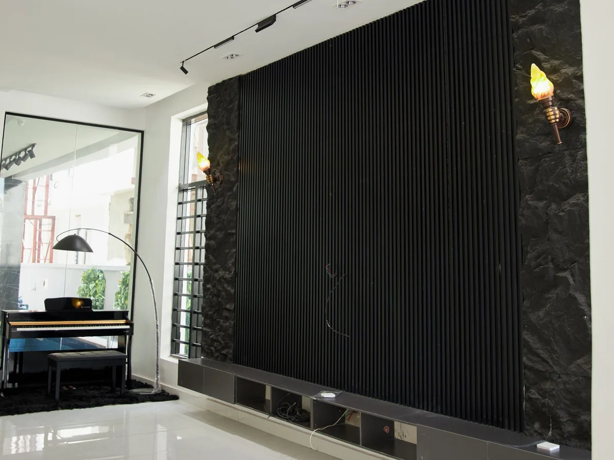 A living room layout with a television, sofa, two chairs, and a clear walkway