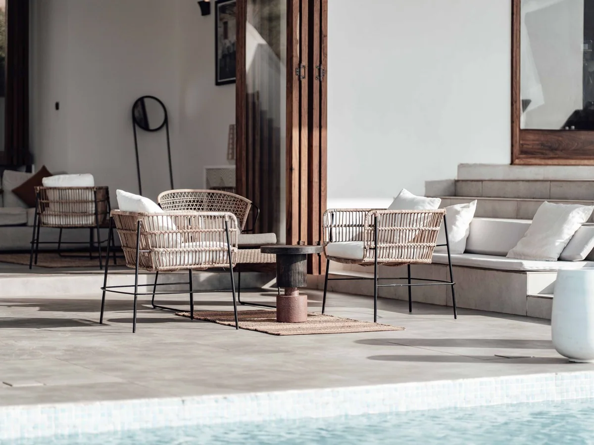 A compact bistro table and two chairs on a city apartment balcony