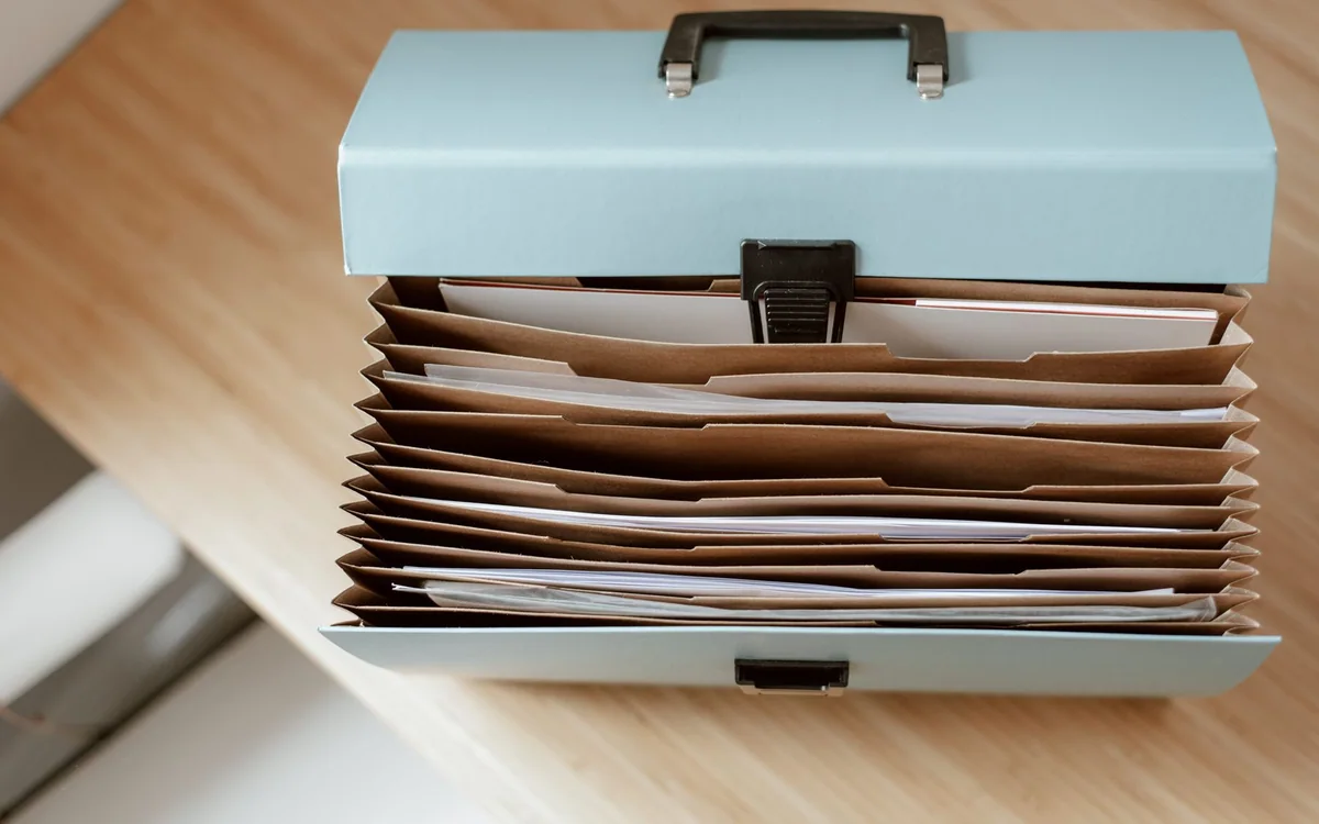 Hands sorting mail into action, file, scan, and shred categories