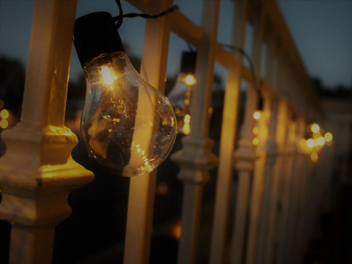 Warm and neutral light bulbs arranged beside a lamp and kitchen fixture