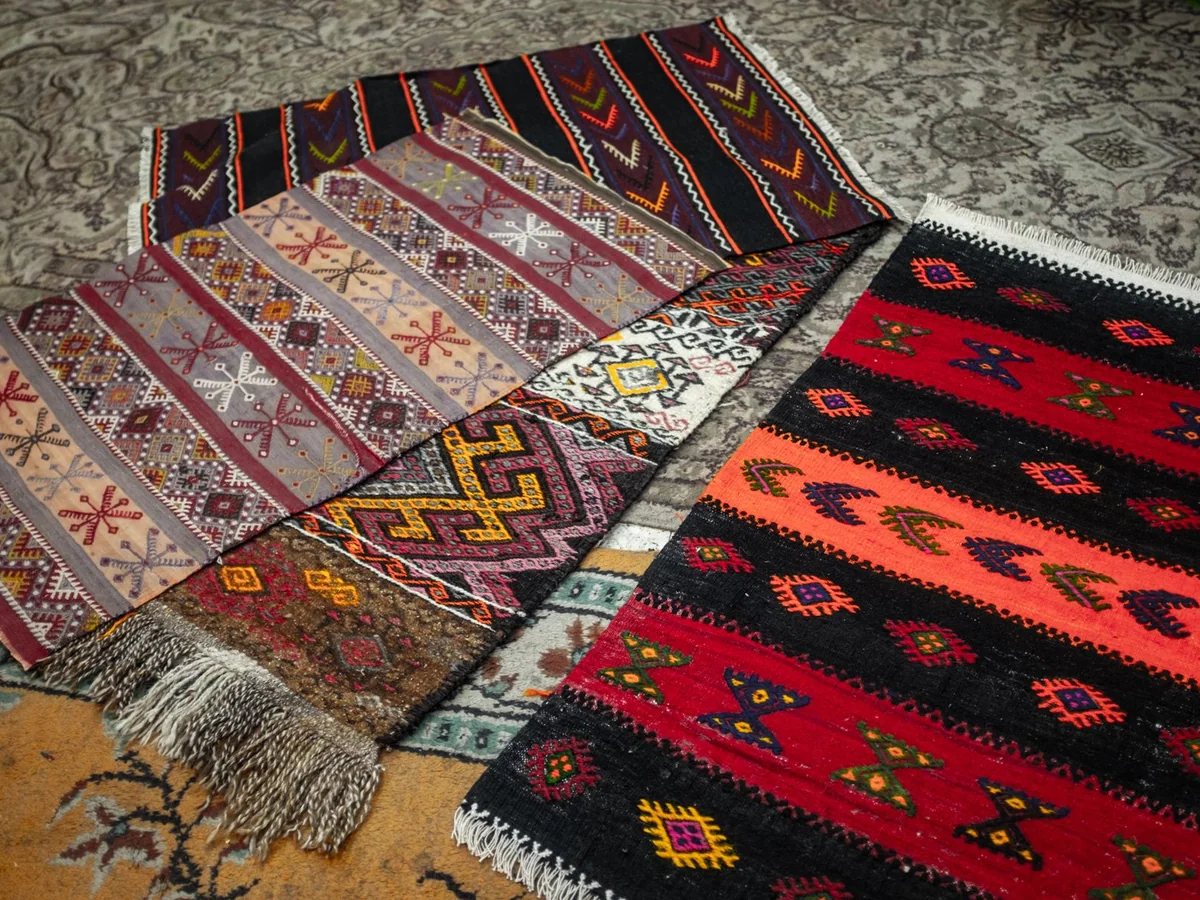 A low-pile area rug in a family living room with a sofa and children's books